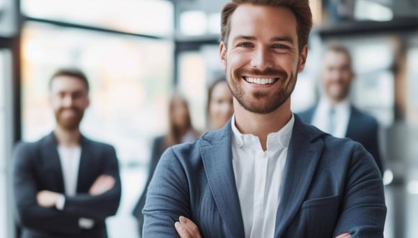 smiling professional with arms crossed colleagues in background-1